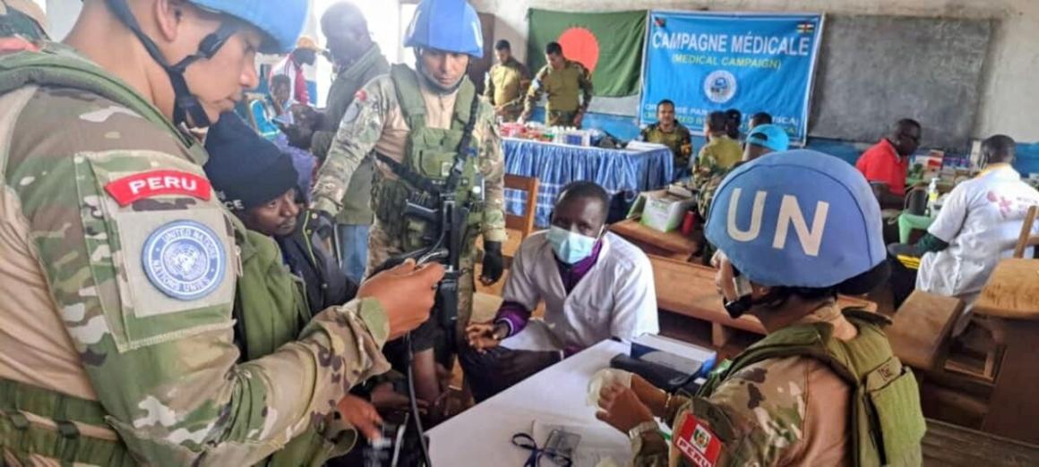Peacekeepers talk with a medic at a medical centre.